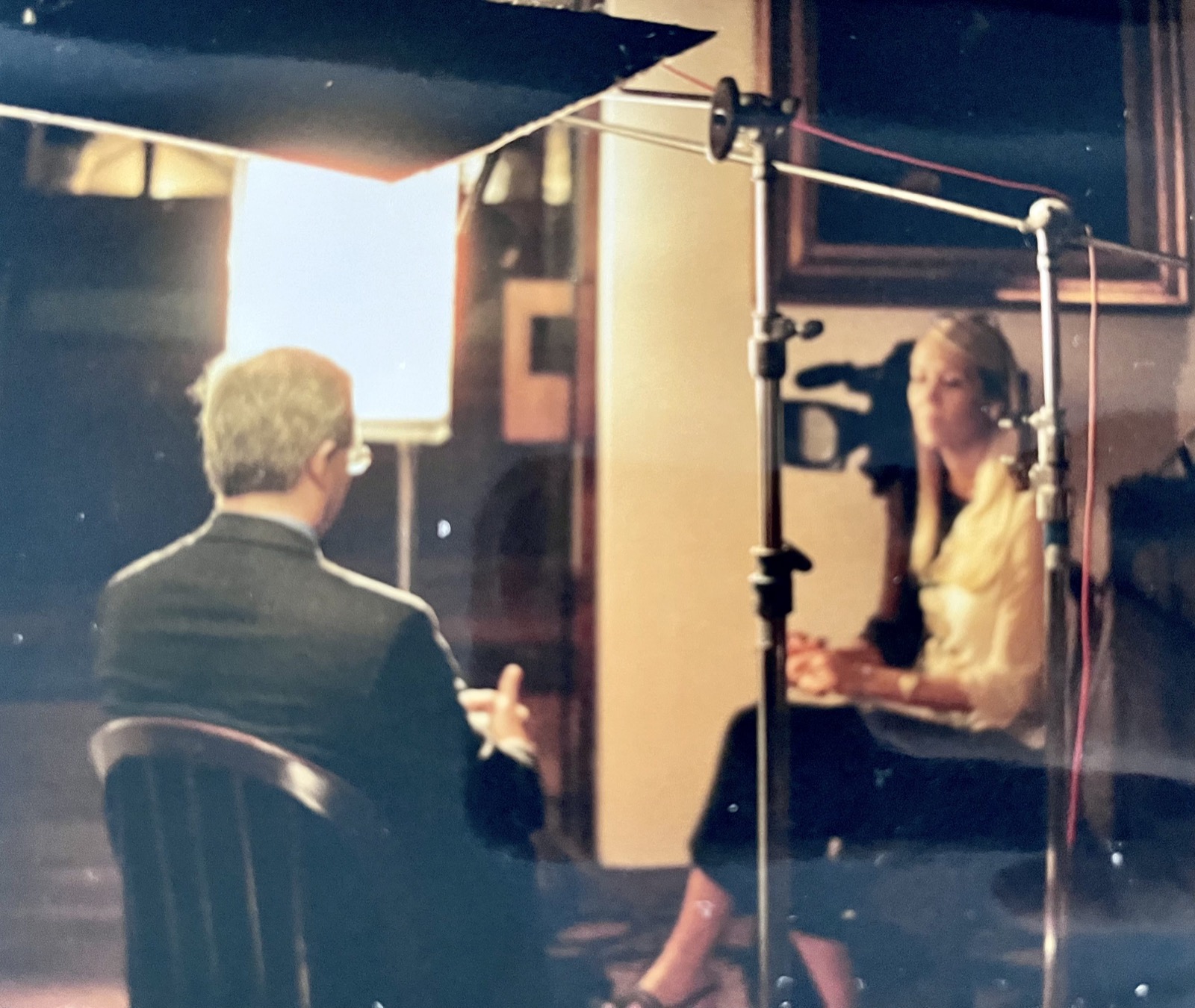 A documentary interview being filmed with lights, camera, and crew